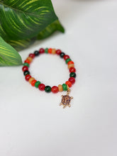 Load image into Gallery viewer, Pan-African Colors Glass Bead Stretch Bracelet with Leopard Turtle Charm | Handmade
